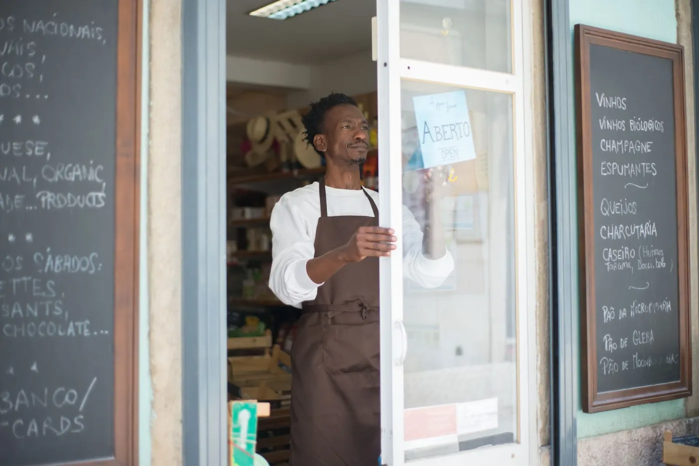 Commerçant en tablier ouvrant la porte de sa boutique
